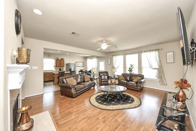 3811 Rosalind Ln, Houston, TX 77053 - living area with a fireplace, a ceiling fan, wood finished floors, and recessed lighting