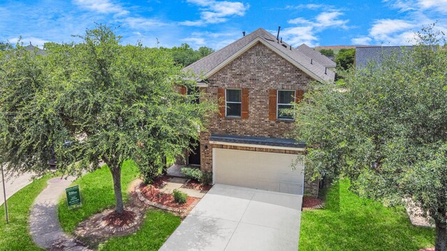 3811 Rosalind Ln, Houston, TX 77053 - traditional home featuring an attached garage, concrete driveway, and brick siding
