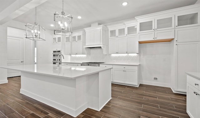 118 Luther Dean Ln, New Waverly, TX 77358 - kitchen with recessed lighting, a chandelier, dark wood-style floors, backsplash, and light countertops
