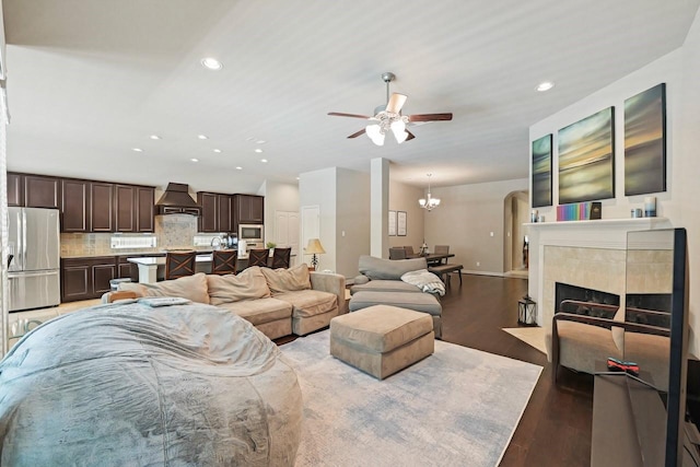166 Hearthshire Cir, Magnolia, TX 77354 - living area with ceiling fan, light wood-style flooring, recessed lighting, a chandelier, and arched walkways