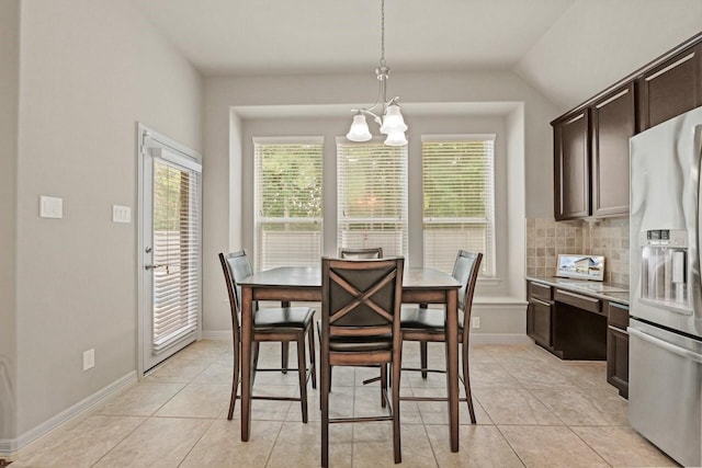 166 Hearthshire Cir, Magnolia, TX 77354 - dining area featuring a chandelier, light tile patterned floors, and lofted ceiling