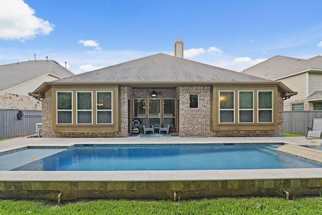166 Hearthshire Cir, Magnolia, TX 77354 - back of house with a ceiling fan, brick siding, a fenced backyard, a patio area, and a chimney
