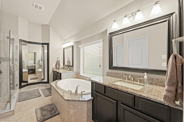166 Hearthshire Cir, Magnolia, TX 77354 - bathroom with a shower stall, two vanities, a bath, lofted ceiling, and tile patterned floors