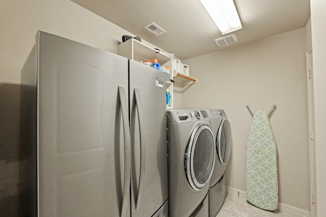 166 Hearthshire Cir, Magnolia, TX 77354 - washroom featuring washer and dryer and baseboards