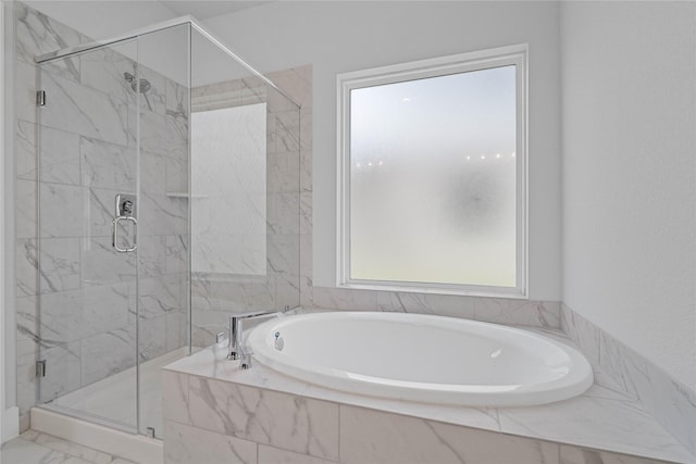 3040 Mesquite Pod Trl, Conroe, TX 77301 - bathroom featuring a garden tub, a marble finish shower, and marble look tile flooring