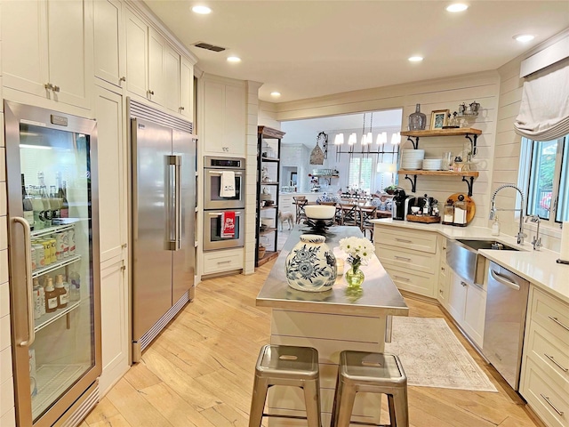 1234 Challenger, Lakeway, TX 78734 - kitchen with appliances with stainless steel finishes, a chandelier, open shelves, healthy amount of natural light, and recessed lighting