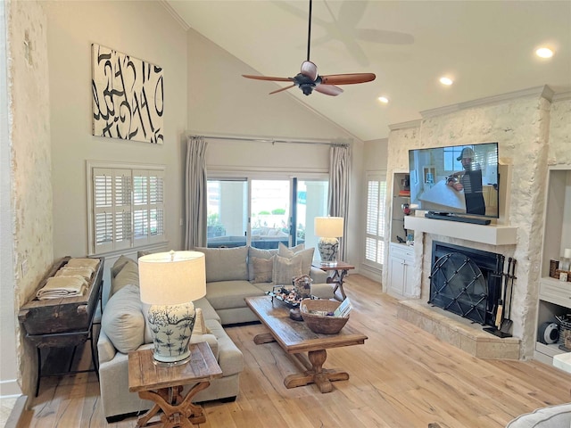 1234 Challenger, Lakeway, TX 78734 - living room featuring a fireplace, hardwood / wood-style flooring, high vaulted ceiling, ceiling fan, and ornamental molding
