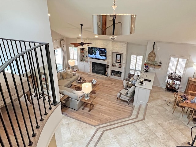 1234 Challenger, Lakeway, TX 78734 - living area with a ceiling fan, a fireplace with raised hearth, stairway, light tile patterned floors, and recessed lighting