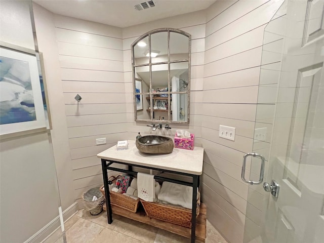 1234 Challenger, Lakeway, TX 78734 - bathroom featuring wooden walls, vanity, a stall shower, and tile patterned flooring