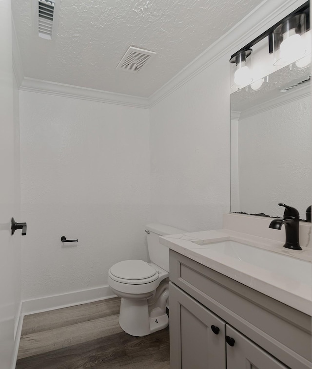 3 Meadow Beauty, The Woodlands, TX 77381 - bathroom with vanity, wood finished floors, a textured ceiling, and ornamental molding