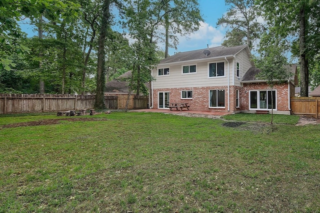 3 Meadow Beauty, The Woodlands, TX 77381 - rear view of property featuring brick siding, a patio area, and a fenced backyard