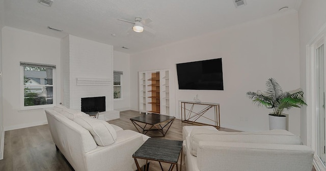 3 Meadow Beauty, The Woodlands, TX 77381 - living area with wood finished floors, ceiling fan, a fireplace, and built in features