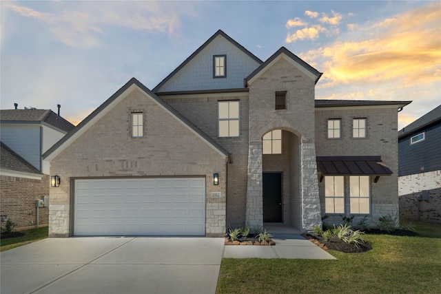 1912 Golden Spruce Ln, Conroe, TX 77301 - french provincial home featuring concrete driveway, a garage, a front yard, stone siding, and brick siding