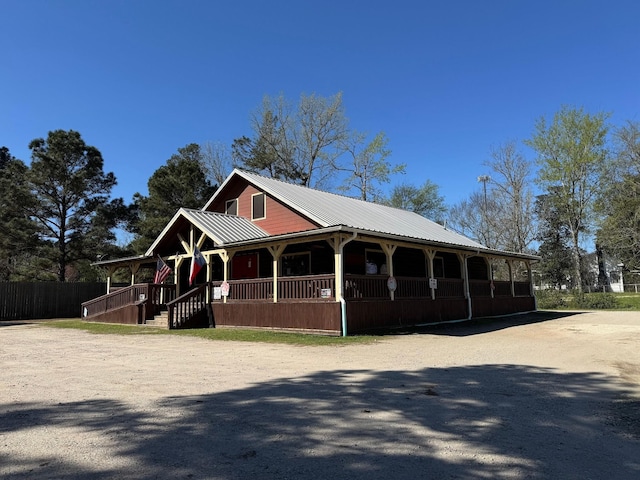 203 W Elder St, Colmesneil, TX 75938 - view of front of property with a metal roof and covered porch
