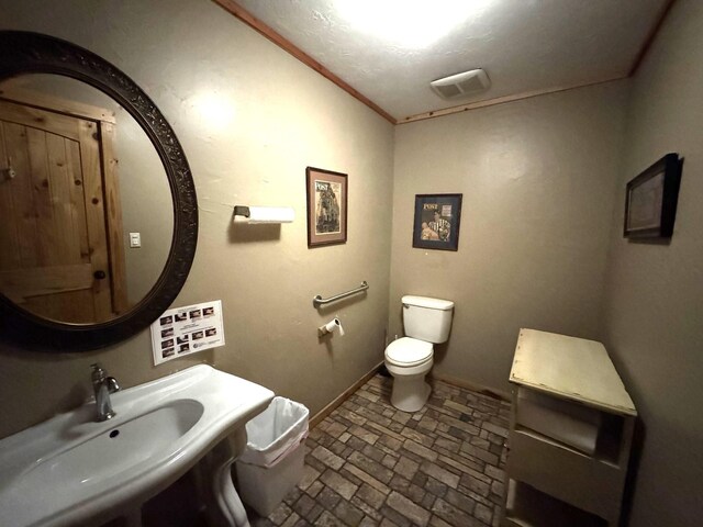 203 W Elder St, Colmesneil, TX 75938 - bathroom featuring toilet and brick patterned floors