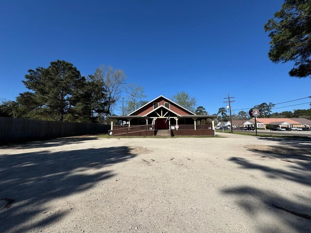 203 W Elder St, Colmesneil, TX 75938 - view of front of house with covered porch and driveway
