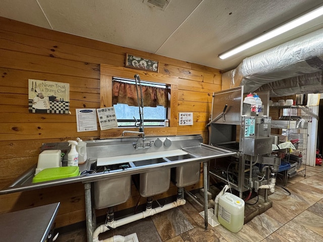 203 W Elder St, Colmesneil, TX 75938 - kitchen featuring wooden walls and a textured ceiling