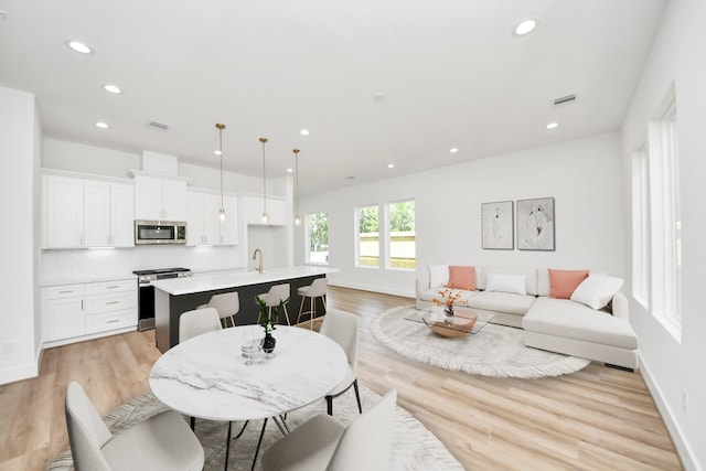 103 Frawley St, Houston, TX 77009 - living room featuring light wood finished floors and recessed lighting