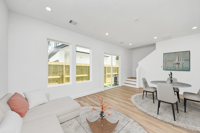 103 Frawley St, Houston, TX 77009 - living area featuring stairway, healthy amount of natural light, wood finished floors, and recessed lighting