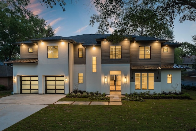 512 W Alkire Lake Dr, Sugar Land, TX 77478 - contemporary home featuring a standing seam roof, stucco siding, a metal roof, and an attached garage