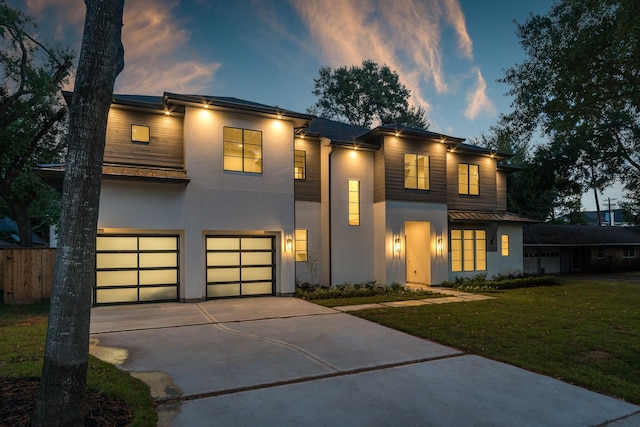 512 W Alkire Lake Dr, Sugar Land, TX 77478 - contemporary house featuring stucco siding, a garage, driveway, a standing seam roof, and a metal roof