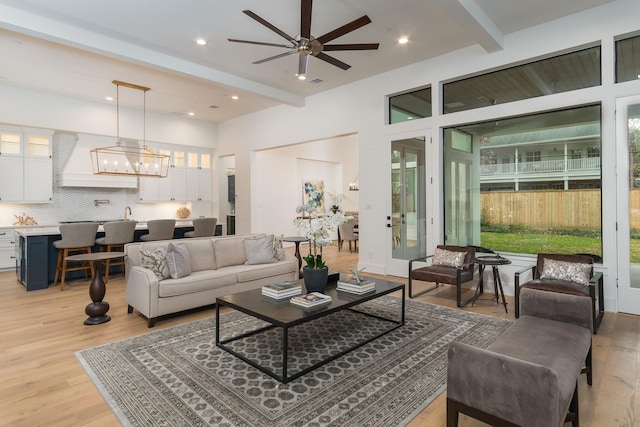 512 W Alkire Lake Dr, Sugar Land, TX 77478 - living area with beamed ceiling, light wood finished floors, a ceiling fan, plenty of natural light, and recessed lighting