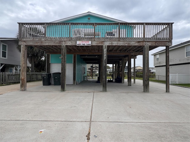 4003 Panola Dr, Galveston, TX 77554 - exterior space with a carport, concrete driveway, a deck, and stairway
