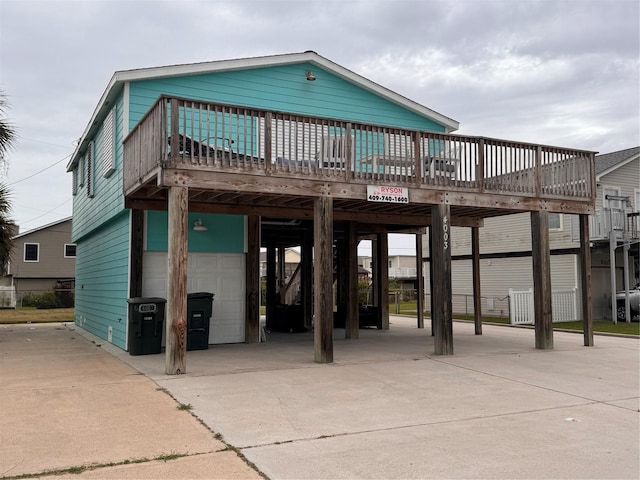 4003 Panola Dr, Galveston, TX 77554 - back of property featuring a carport, concrete driveway, and a deck