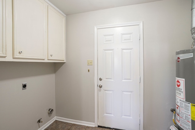 5606 Water Leaf Ln, Houston, TX 77088 - laundry room with water heater, cabinet space, electric dryer hookup, dark tile patterned floors, and hookup for a gas dryer