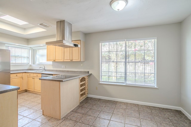 5606 Water Leaf Ln, Houston, TX 77088 - kitchen featuring island range hood, light brown cabinetry, stainless steel appliances, a peninsula, and light tile patterned floors