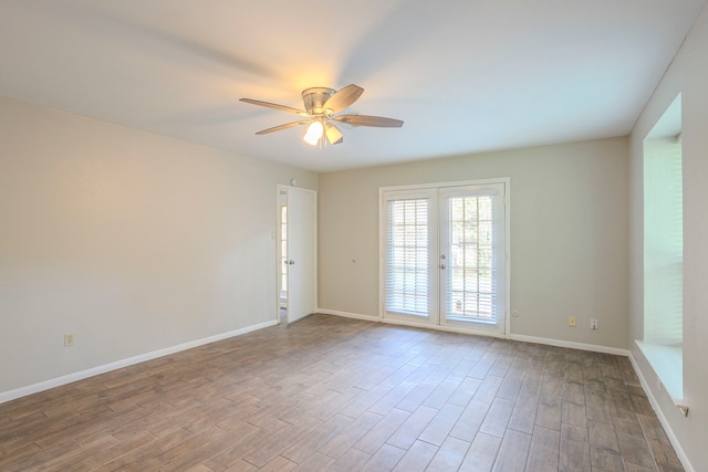 5606 Water Leaf Ln, Houston, TX 77088 - spare room featuring french doors, a ceiling fan, and wood finished floors