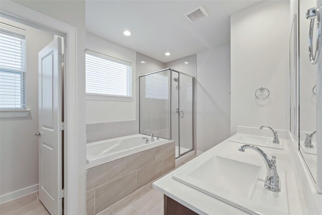 1013 Erin St Unit W, Houston, TX 77009 - full bathroom with a bath, a shower stall, double vanity, and recessed lighting