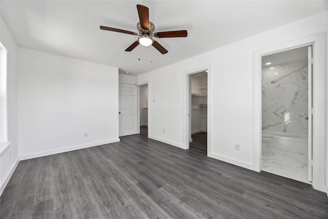 7904 Shotwell St, Houston, TX 77016 - unfurnished bedroom featuring a walk in closet, a closet, dark wood-type flooring, ceiling fan, and connected bathroom