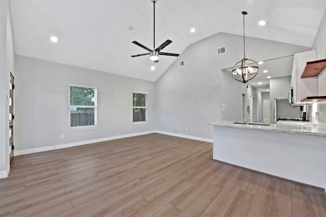 411 E 37th St, Houston, TX 77018 - unfurnished living room featuring a ceiling fan, light wood-type flooring, high vaulted ceiling, recessed lighting, and a chandelier