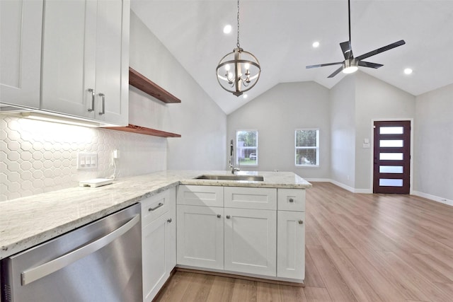 411 E 37th St, Houston, TX 77018 - kitchen with stainless steel dishwasher, open shelves, a peninsula, open floor plan, and white cabinets