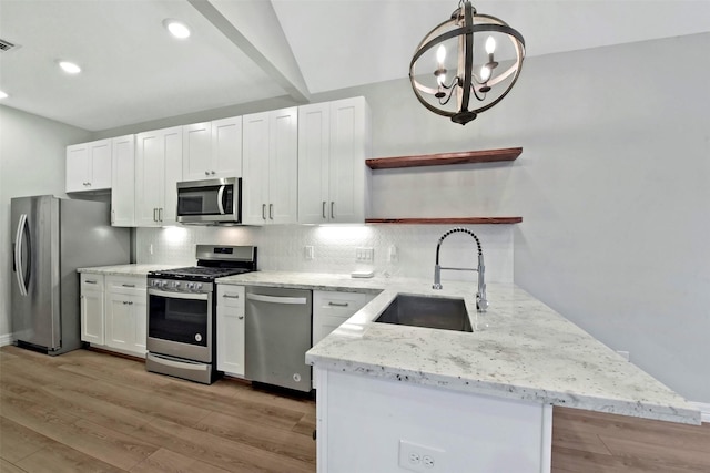 411 E 37th St, Houston, TX 77018 - kitchen with appliances with stainless steel finishes, open shelves, white cabinetry, tasteful backsplash, and light wood-type flooring