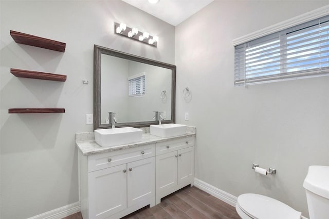 411 E 37th St, Houston, TX 77018 - bathroom featuring wood finished floors and double vanity