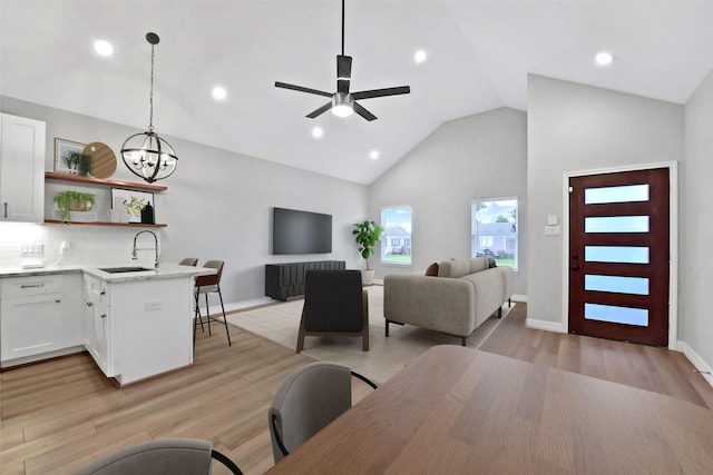 411 E 37th St, Houston, TX 77018 - living room with a ceiling fan, a chandelier, recessed lighting, light wood-type flooring, and high vaulted ceiling