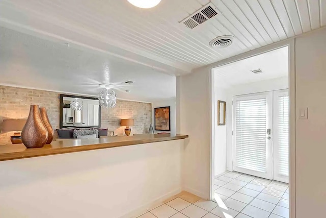 1265 Du Barry Ln, Houston, TX 77018 - kitchen featuring light tile patterned flooring and brick wall