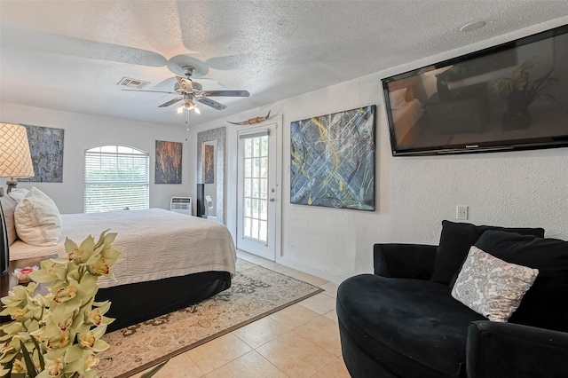 1265 Du Barry Ln, Houston, TX 77018 - bedroom with access to outside, light tile patterned floors, a textured ceiling, a textured wall, and a ceiling fan