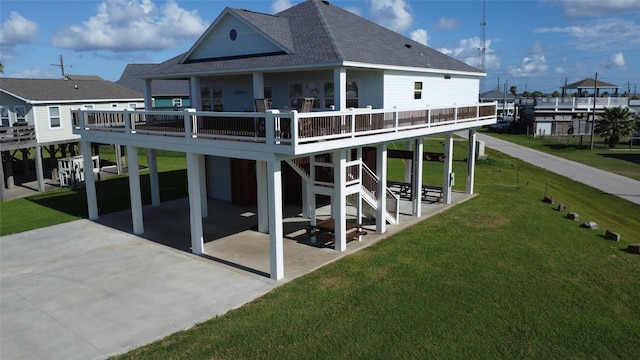 2429 Sand Bar Ln, Crystal Beach, TX 77650 - back of house with roof with shingles, a patio area, a yard, and a wooden deck