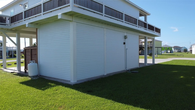 2429 Sand Bar Ln, Crystal Beach, TX 77650 - view of side of home with a lawn and a balcony
