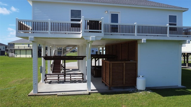 2429 Sand Bar Ln, Crystal Beach, TX 77650 - back of house featuring a yard, roof with shingles, stairway, and a wooden deck