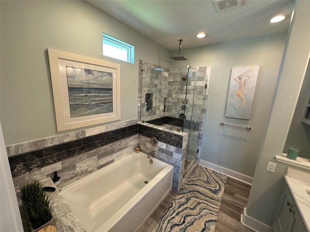 2429 Sand Bar Ln, Crystal Beach, TX 77650 - full bathroom with a garden tub, a stall shower, vanity, and wood finished floors