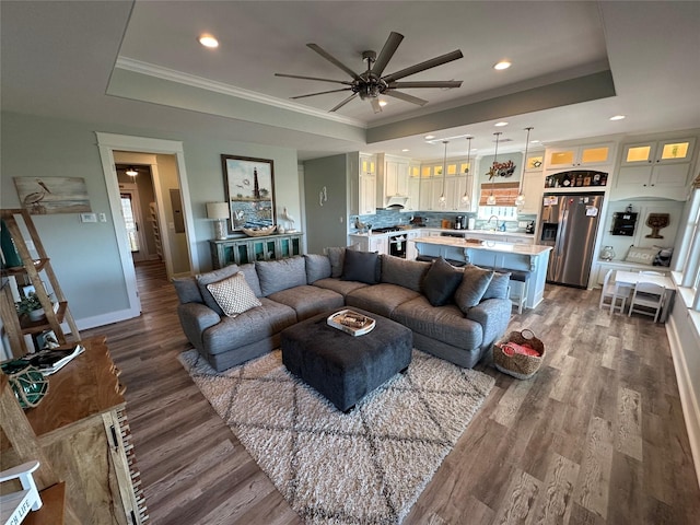 2429 Sand Bar Ln, Crystal Beach, TX 77650 - living room featuring a tray ceiling, a ceiling fan, wood finished floors, recessed lighting, and crown molding