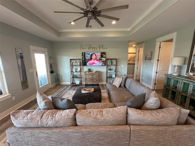 2429 Sand Bar Ln, Crystal Beach, TX 77650 - living room featuring a tray ceiling, wood finished floors, a ceiling fan, crown molding, and recessed lighting