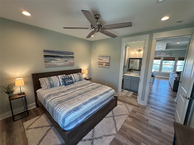 2429 Sand Bar Ln, Crystal Beach, TX 77650 - bedroom featuring wood finished floors, recessed lighting, ceiling fan, and ensuite bathroom