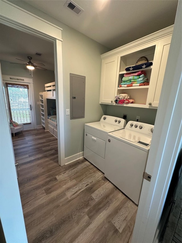 2429 Sand Bar Ln, Crystal Beach, TX 77650 - laundry room with electric panel, cabinet space, washing machine and clothes dryer, and dark wood-type flooring