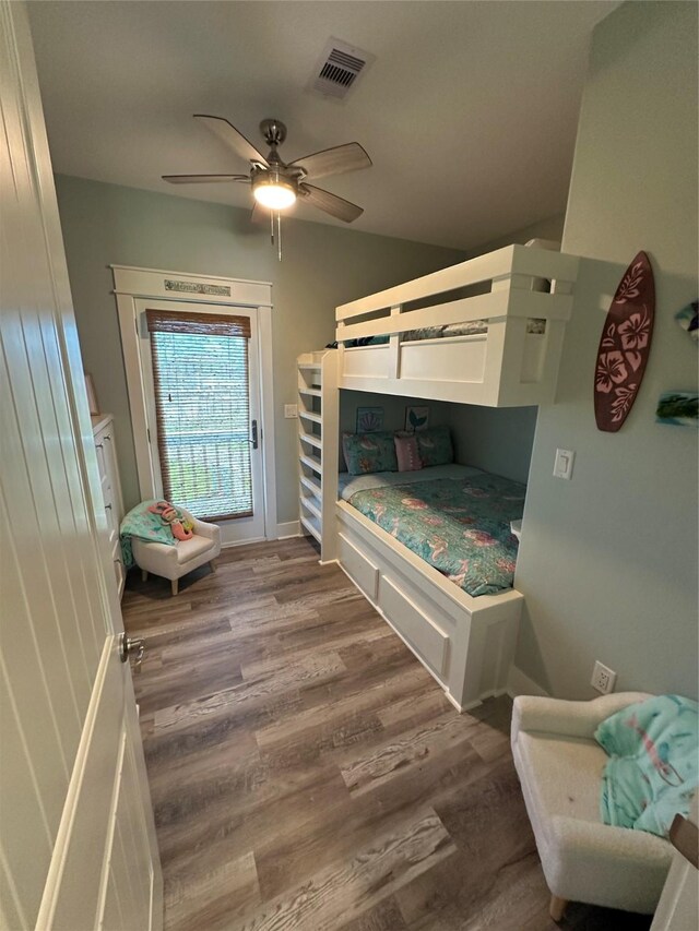 2429 Sand Bar Ln, Crystal Beach, TX 77650 - bedroom with wood finished floors, access to outside, and ceiling fan