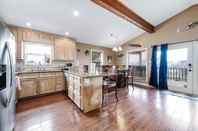 211 Anchor Dr, Freeport, TX 77541 - kitchen with light brown cabinets, a peninsula, a kitchen bar, a chandelier, and dark wood-style floors